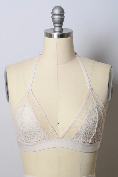 Crochet T-back bralette from Leto Collection featuring natural-colored, intricate crochet design and adjustable straps.