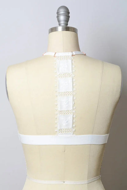 White crochet T-back bralette from Leto Collection with intricate lace detailing and comfortable fit.